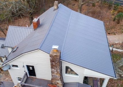 Gray corrugated metal roof with a vent
