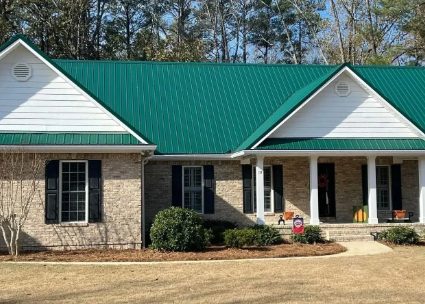 Green metal roof on a brick ranch