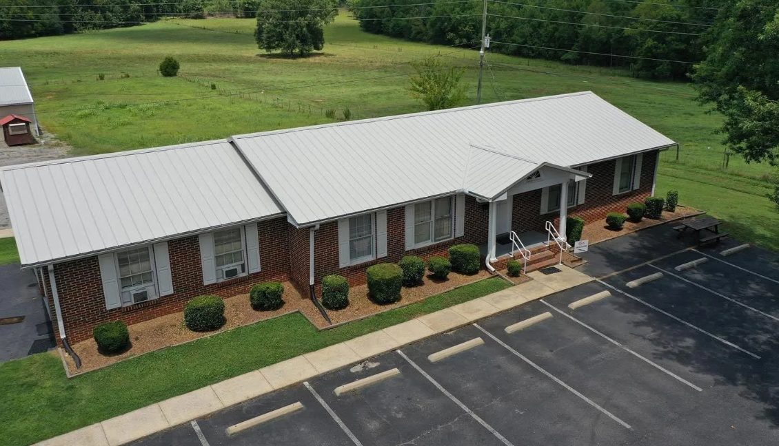 Silver metal roof on a brick commercial building